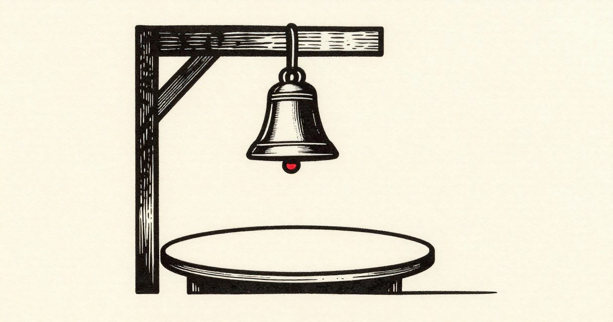 A single large bell hanging from a wooden beam above a circular table in a quiet hall.